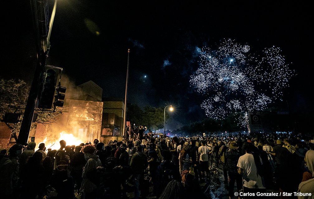 Fireworks were set off as the Minneapolis 3rd Police Precinct burned on Thursday night