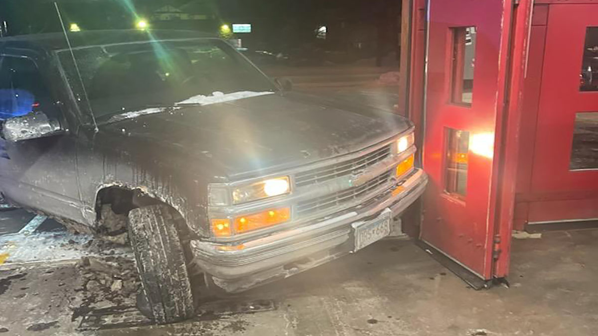 Firefighters helped protect a woman who went to the fire station after a man driving a truck refused to stop following her and crashed into the station on Thursday night, the Minneapolis Police Department says