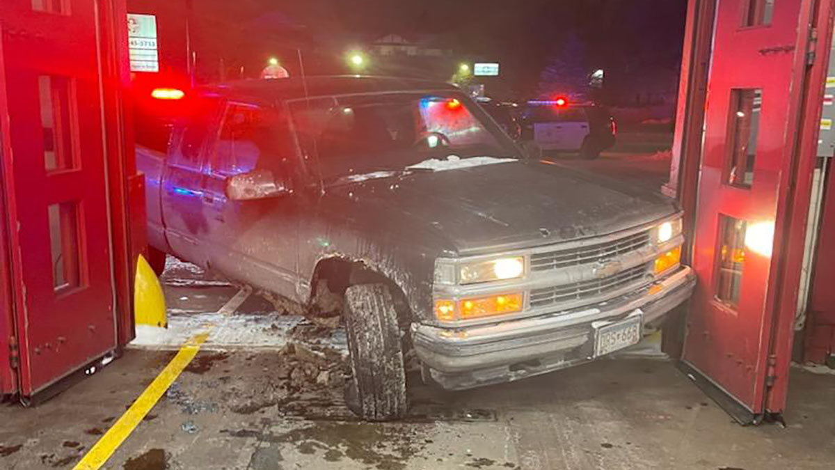 Firefighters helped protect a woman who went to the fire station after a man driving a truck refused to stop following her and crashed into the station on Thursday night, the Minneapolis Police Department says