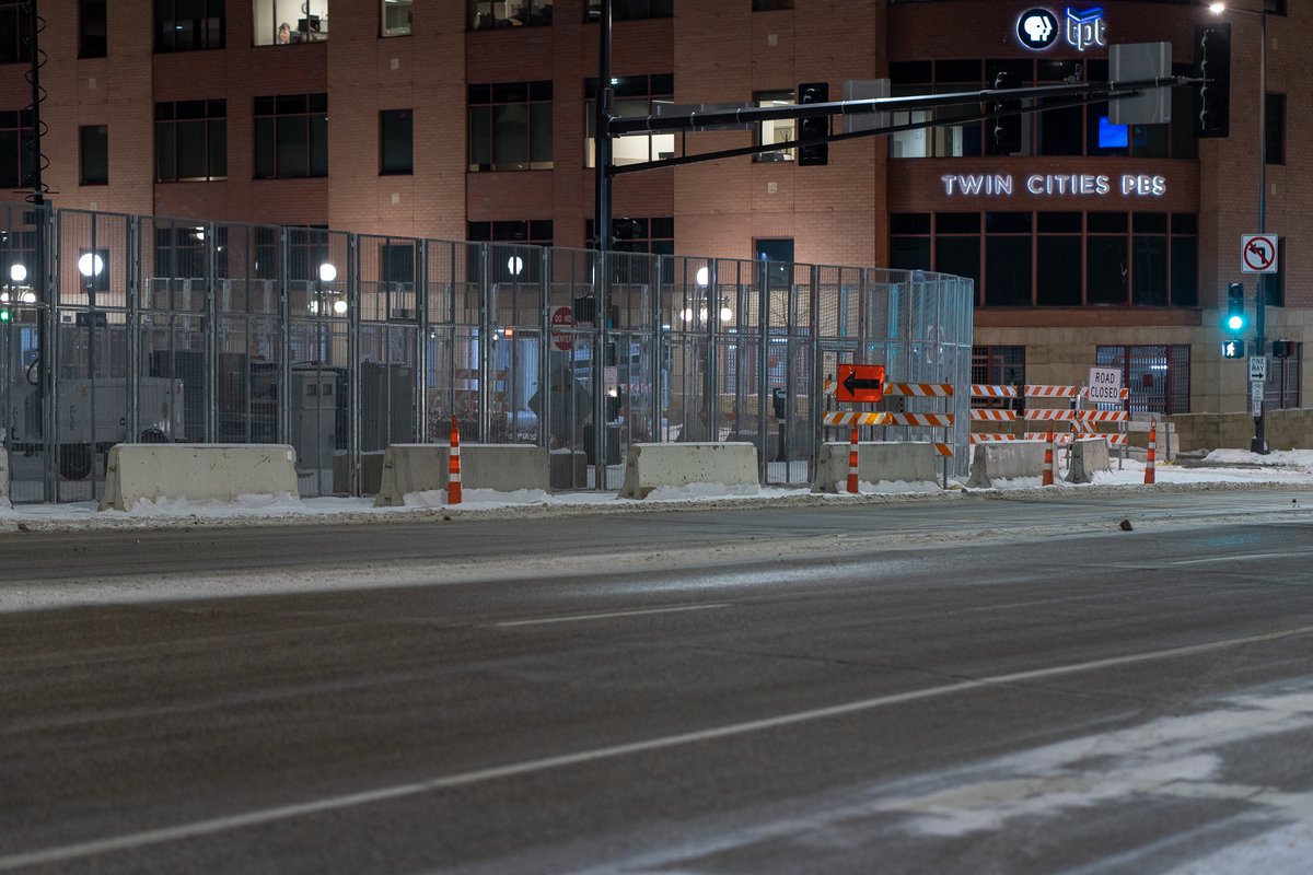 The Federal Courthouse in St. Paul and Ramsey County Downtown Service Center behind security fencing the night before opening statements in trial of officers accused of violating George Floyd's civil rights. Barricades block off a block to be used as a public gathering space