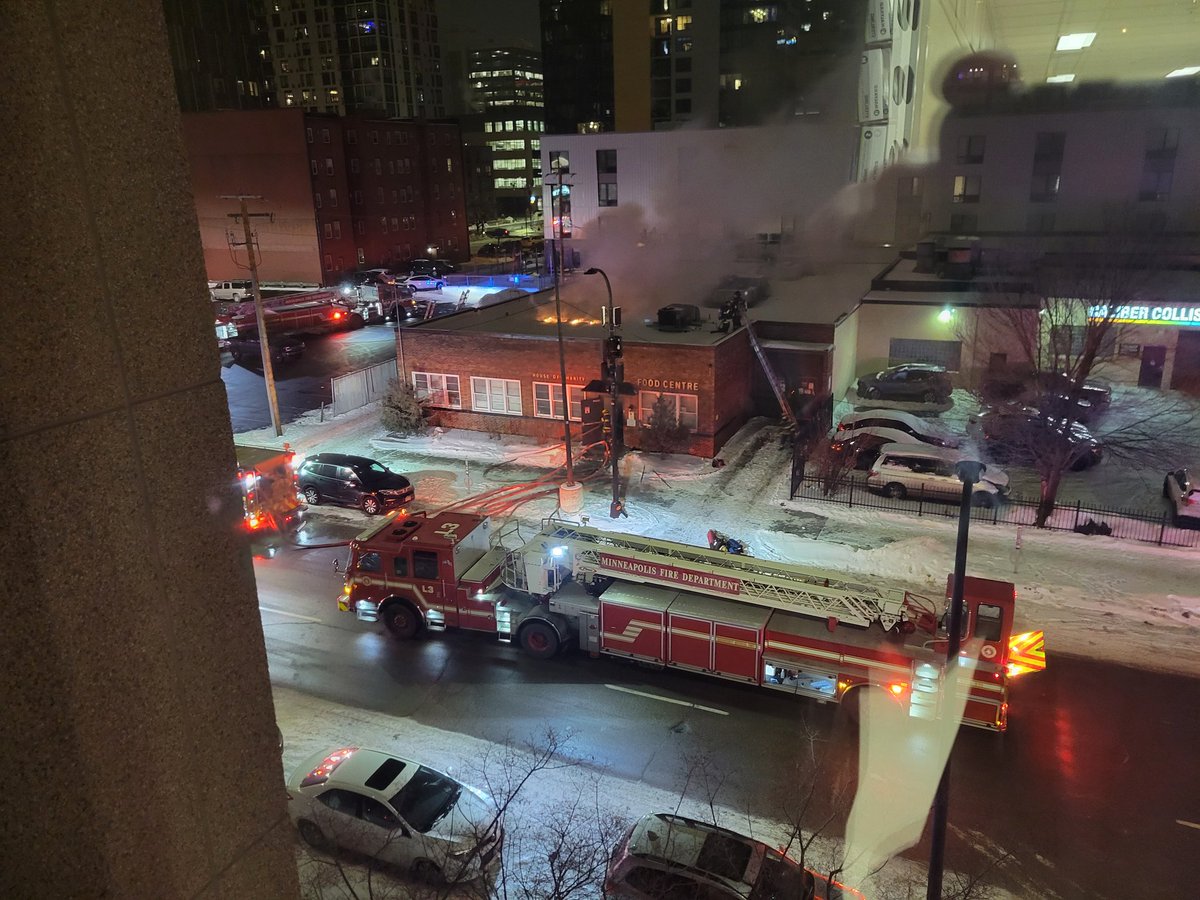 MINNEAPOLIS: Building Fire - 714 Park Ave (House Of Charities) - Fire department on scene of a one-story commercial building with fire through the roof. Crews are backing out and going defensive.