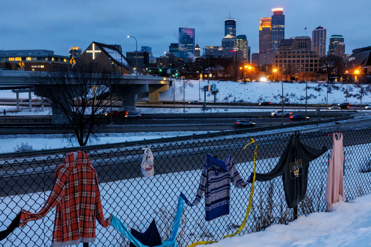 Cedar Riverside encampment residents push to cart near 15th Avenue South and 6th Street South in Minneapolis on Wednesday. The camp will be evicted this morning because it was the scene of a fatal shooting last week.  