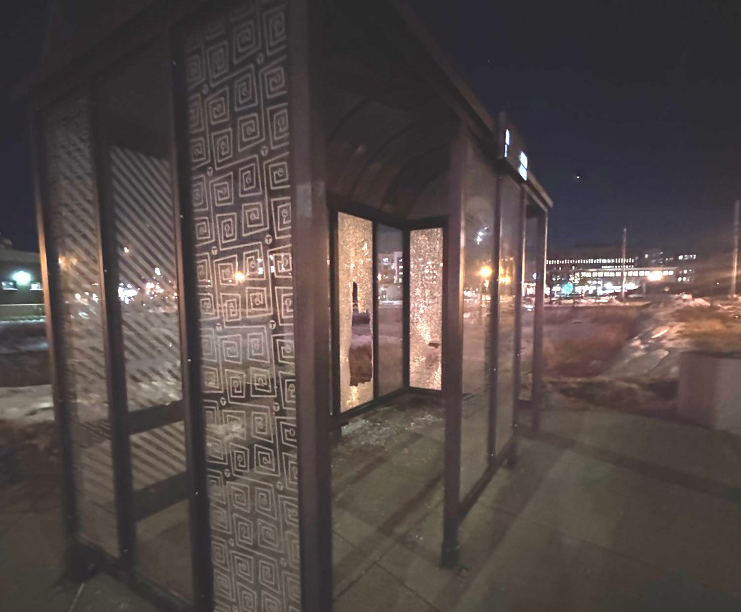 Damaged bus shelter near UMN campus in SE Minneapolis, Oak St and University