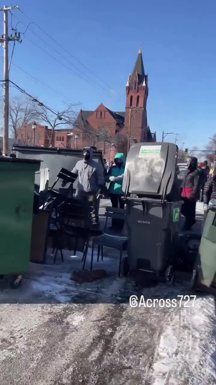 Protesters have barricaded the roadway after an ICE-involved shooting, trapping federal agents at the scene. Crowds are blocking exits as tensions explode and officers reportedly deploy chemical irritants to force a way out