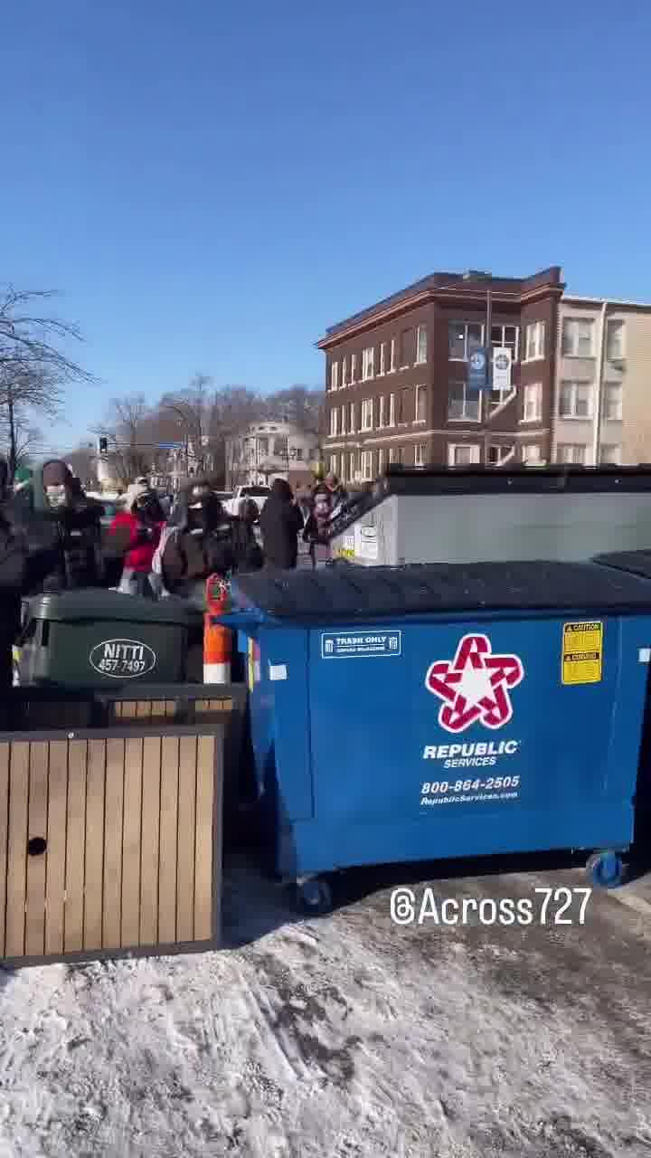 Protesters have barricaded the roadway after an ICE-involved shooting, trapping federal agents at the scene. Crowds are blocking exits as tensions explode and officers reportedly deploy chemical irritants to force a way out